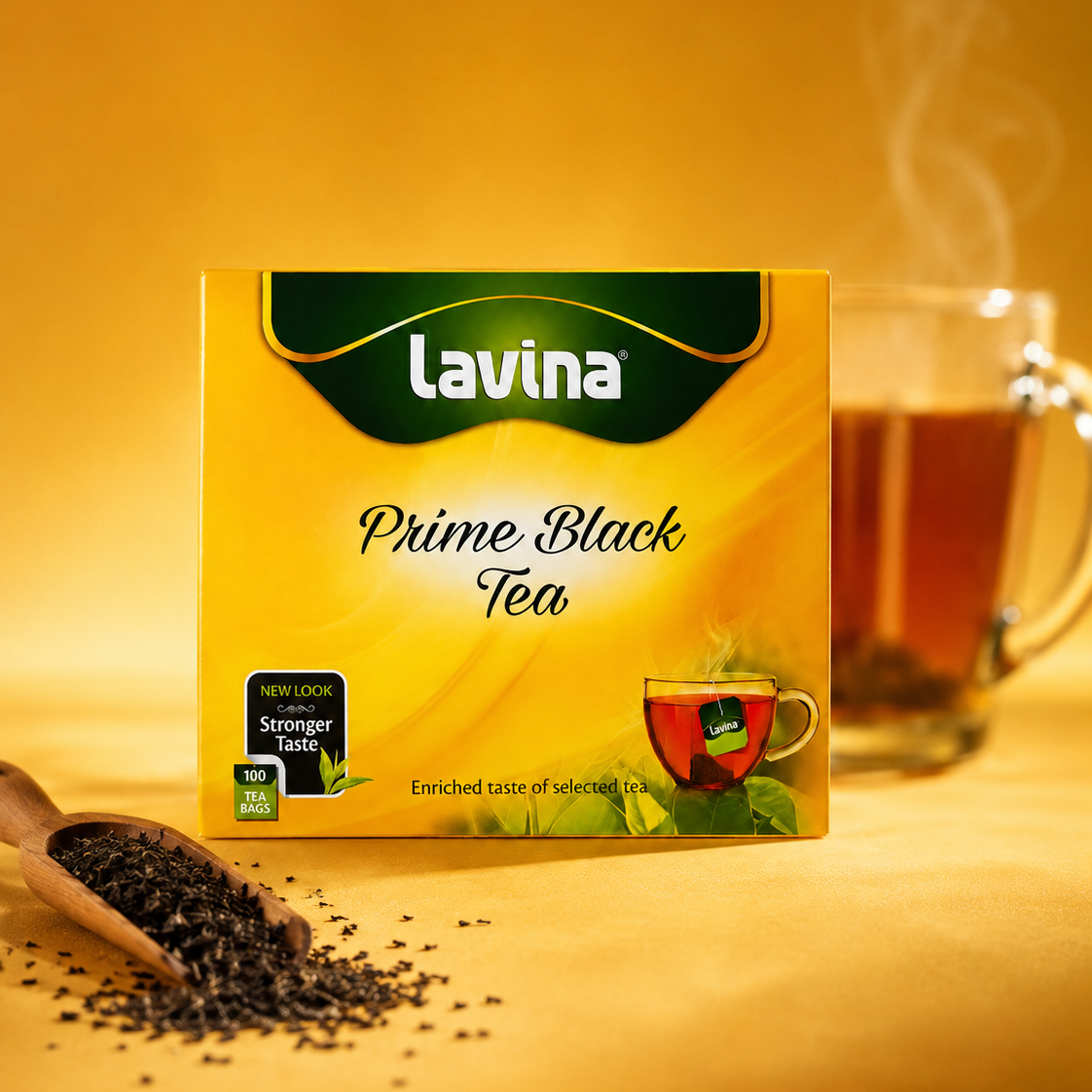 A box of Lavina Prime Black Tea on a warm golden background, with a glass mug of tea and loose tea leaves in a wooden scoop in the background.